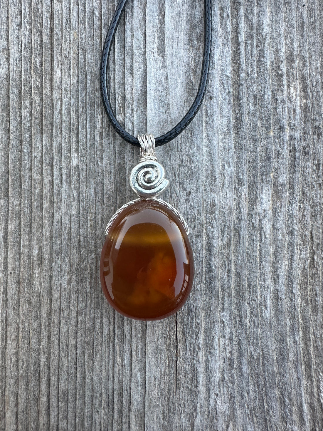 Carnelian for Courage, Success and Creativity. Swirl to Signify Consciousness.