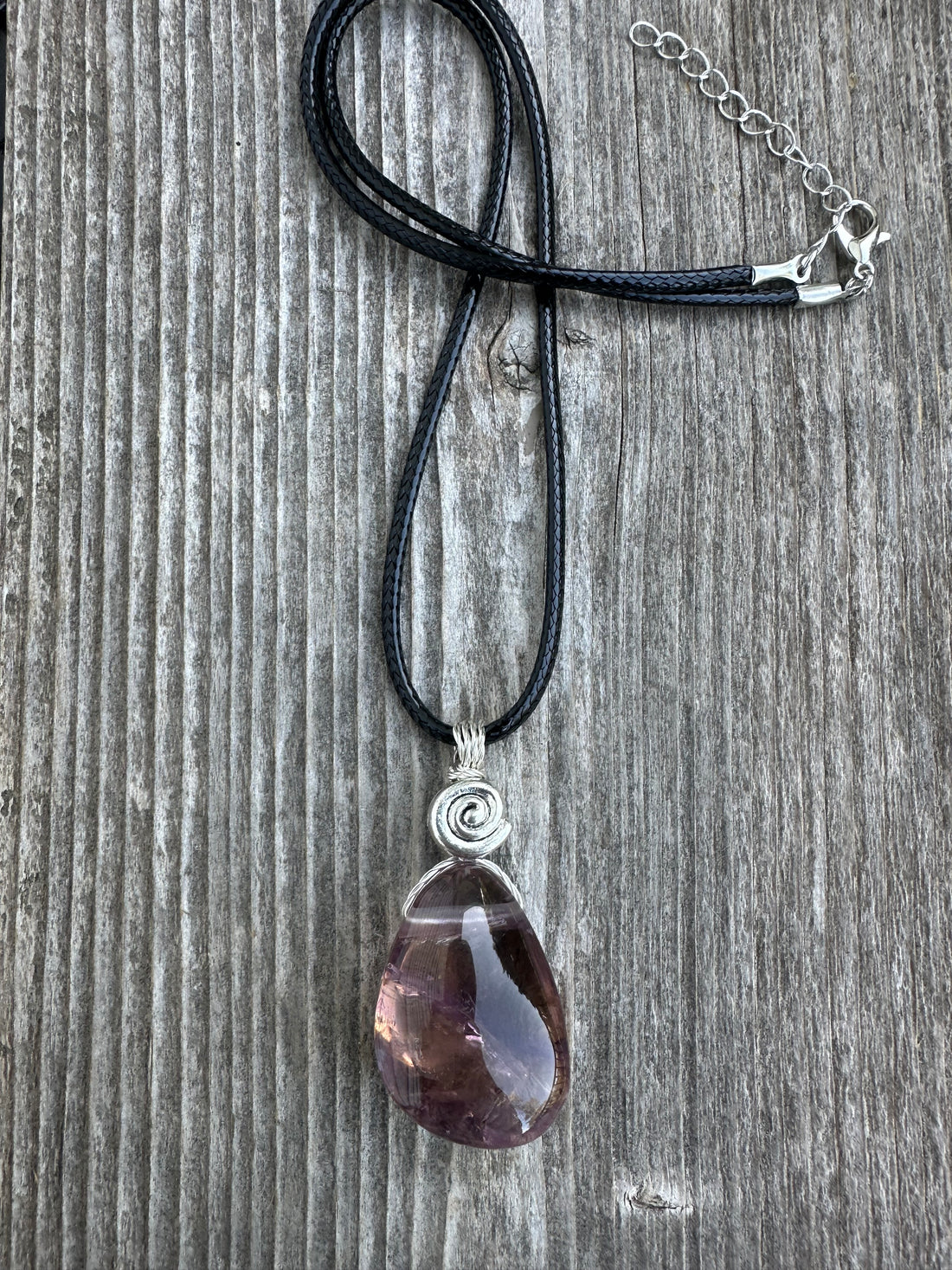 Ametrine for Connecting Physical and Metaphysical Realms, Clarity, and Harmony. Swirl to Signify Consciousness.