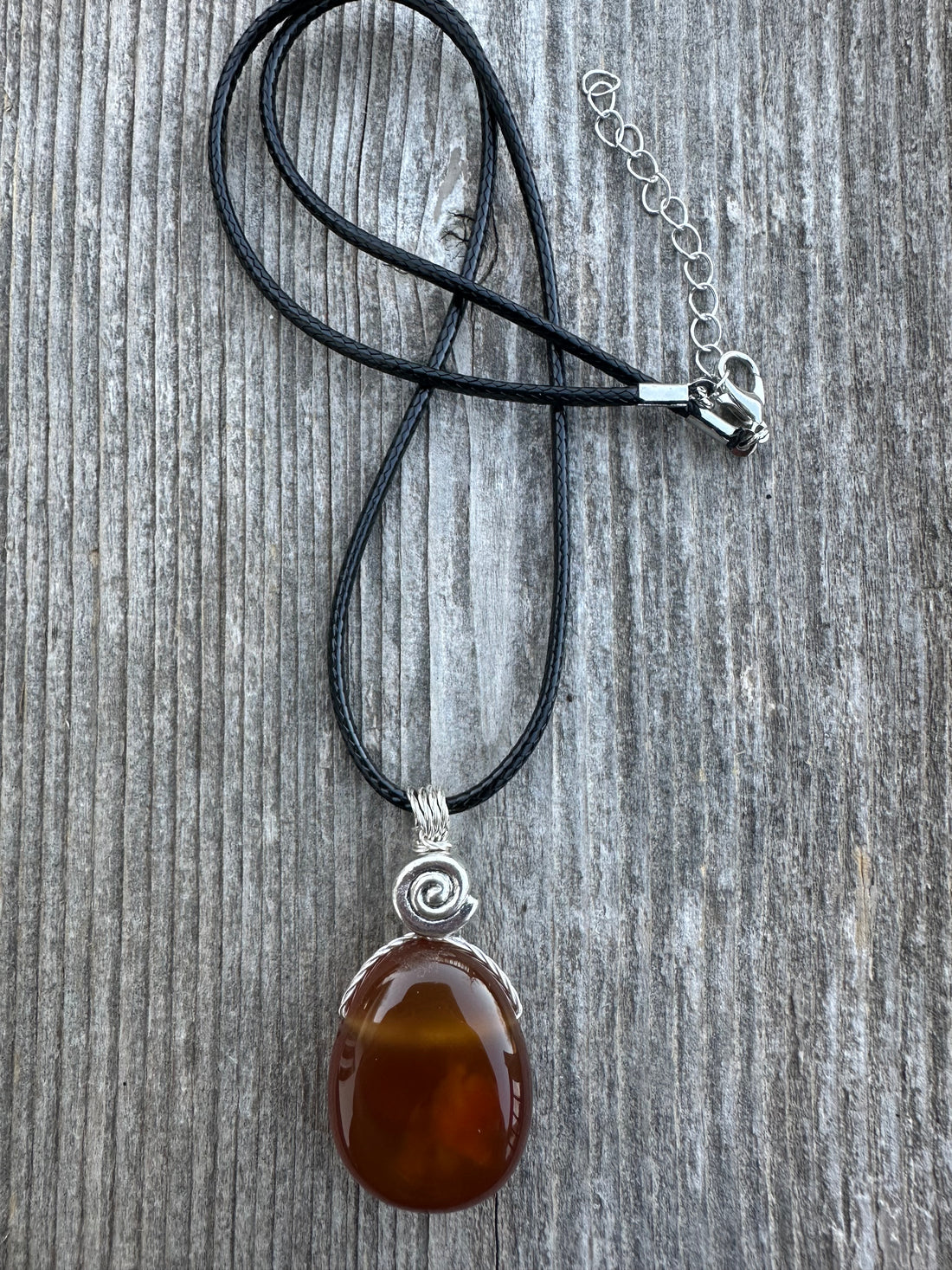 Carnelian for Courage, Success and Creativity. Swirl to Signify Consciousness.