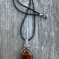 Carnelian for Courage, Success and Creativity. Swirl to Signify Consciousness.