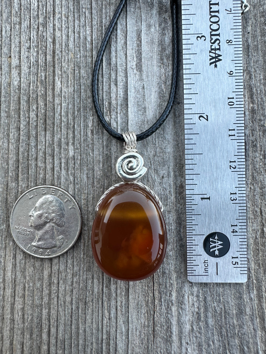 Carnelian for Courage, Success and Creativity. Swirl to Signify Consciousness.