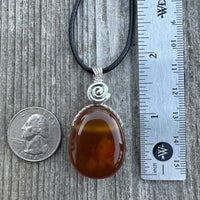 Carnelian for Courage, Success and Creativity. Swirl to Signify Consciousness.