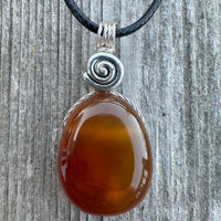 Carnelian for Courage, Success and Creativity. Swirl to Signify Consciousness.
