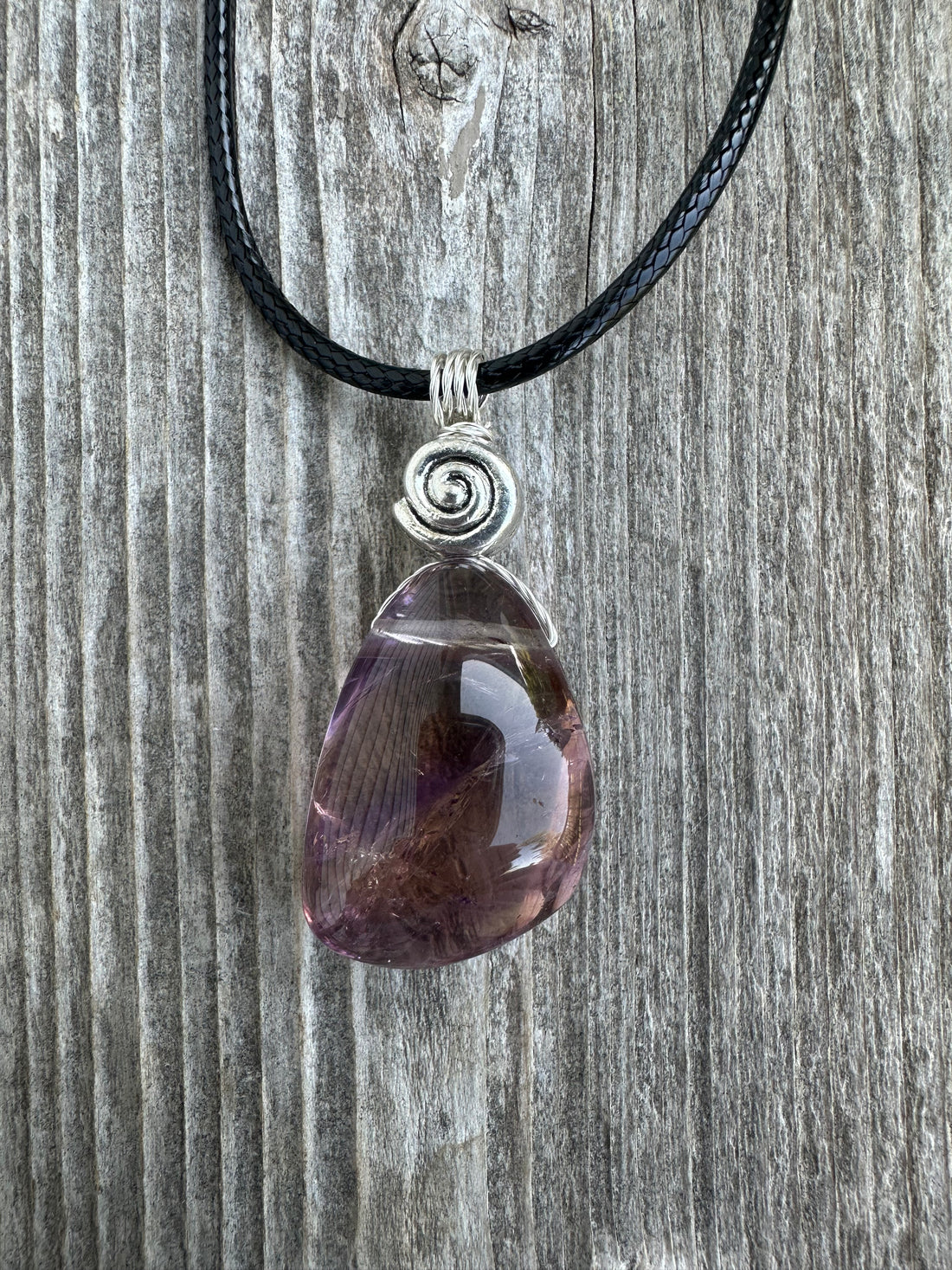 Ametrine for Connecting Physical and Metaphysical Realms, Clarity, and Harmony. Swirl to Signify Consciousness.