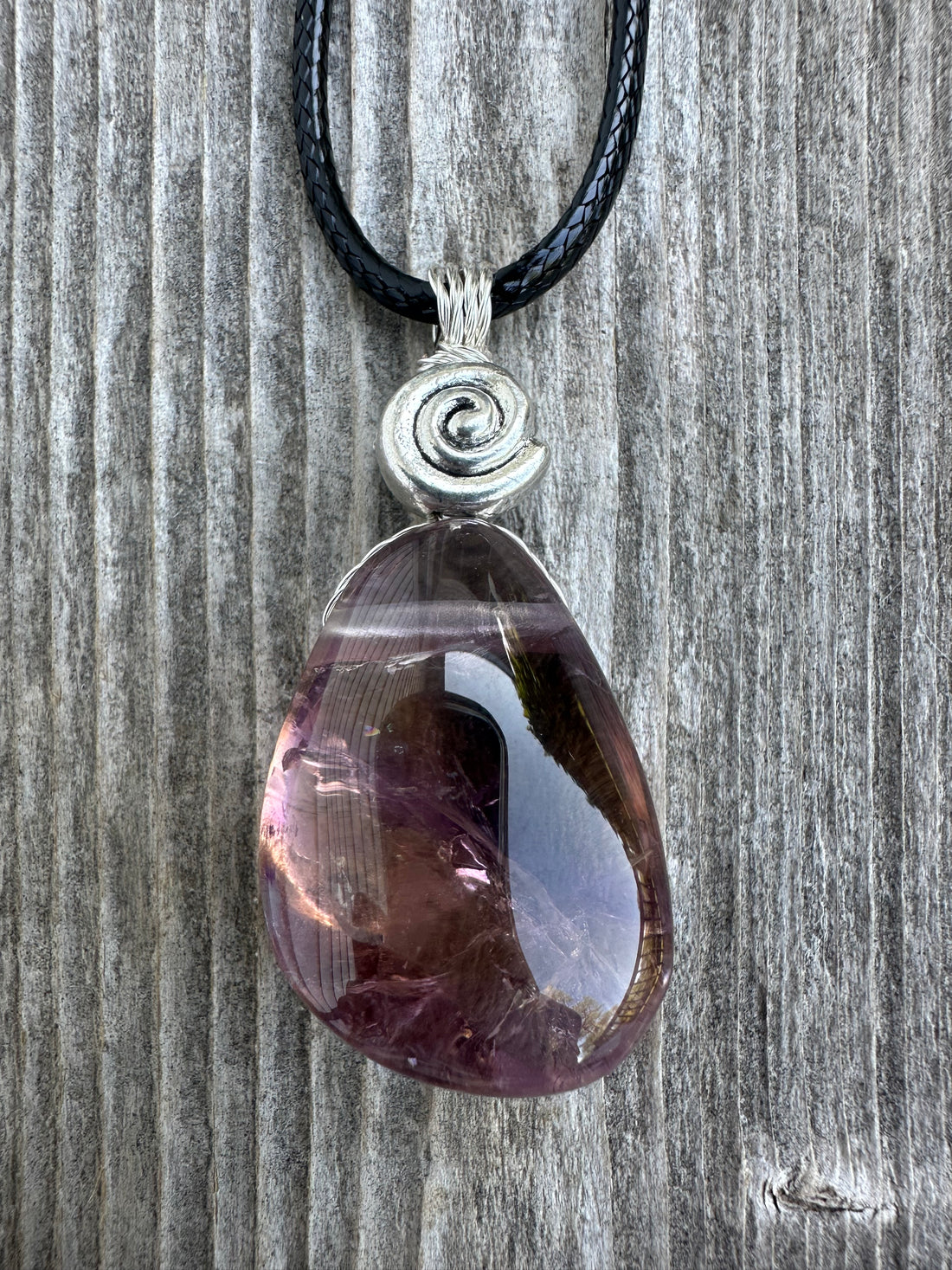 Ametrine for Connecting Physical and Metaphysical Realms, Clarity, and Harmony. Swirl to Signify Consciousness.