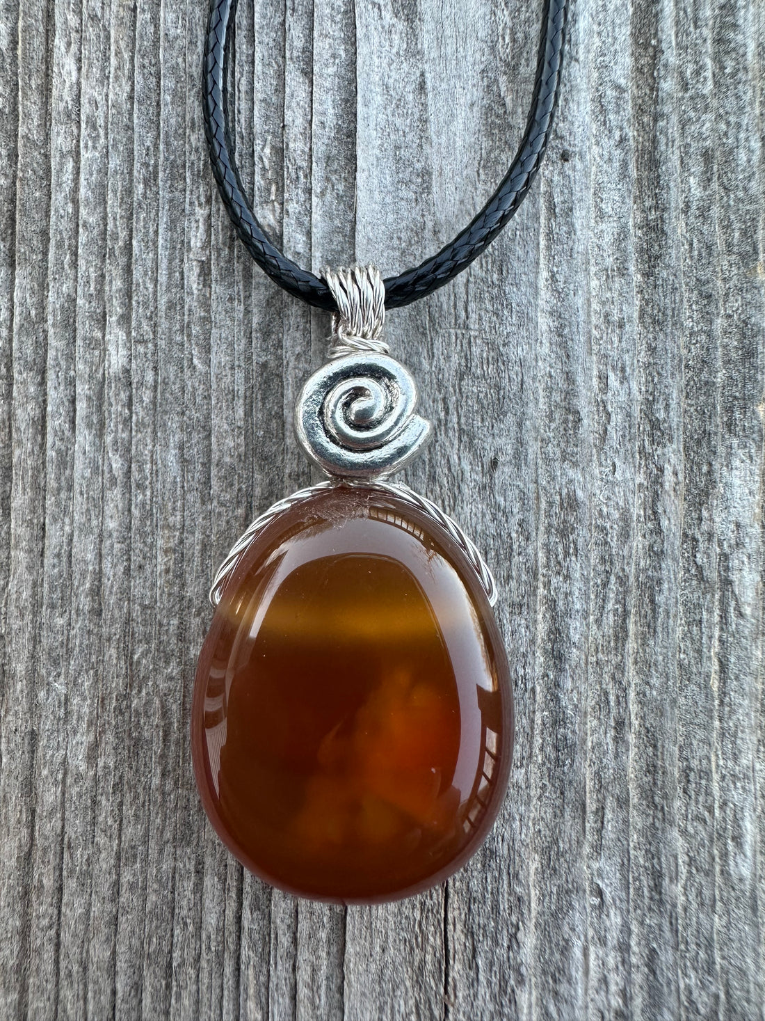 Carnelian for Courage, Success and Creativity. Swirl to Signify Consciousness.