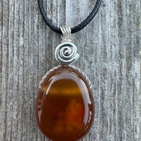 Carnelian for Courage, Success and Creativity. Swirl to Signify Consciousness.