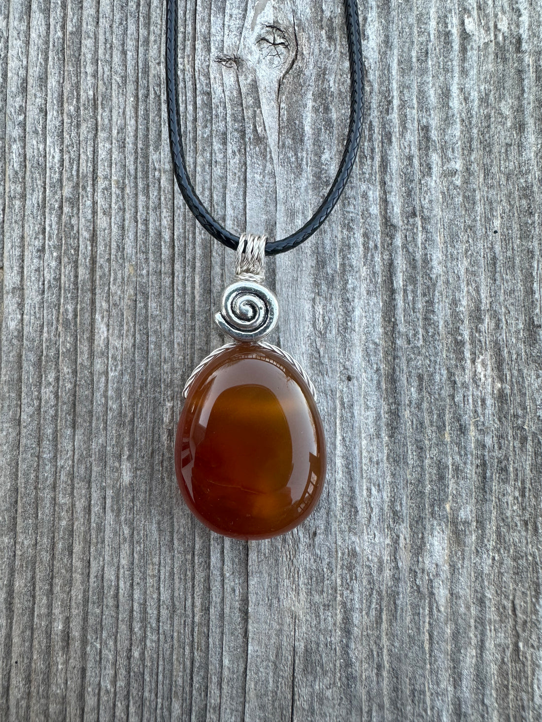 Carnelian for Courage, Success and Creativity. Swirl to Signify Consciousness.