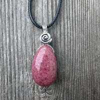 Rhodonite for Compassion, Balancing Emotions, and Self Confidence. Swirl to Signify Consciousness.