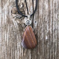 Rhyolite for Igniting Potential, Strength and Creativity. Swirl to Signify Consciousness.