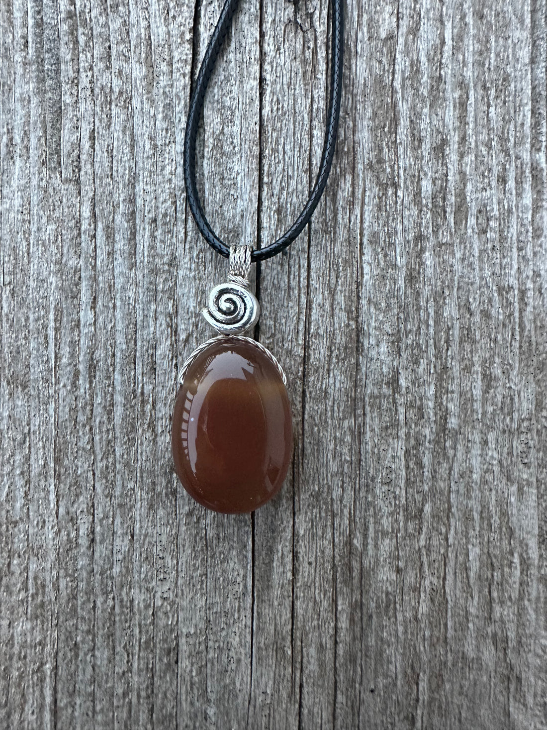 Carnelian for Courage, Success and Creativity. Swirl to Signify Consciousness.