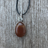 Carnelian for Courage, Success and Creativity. Swirl to Signify Consciousness.