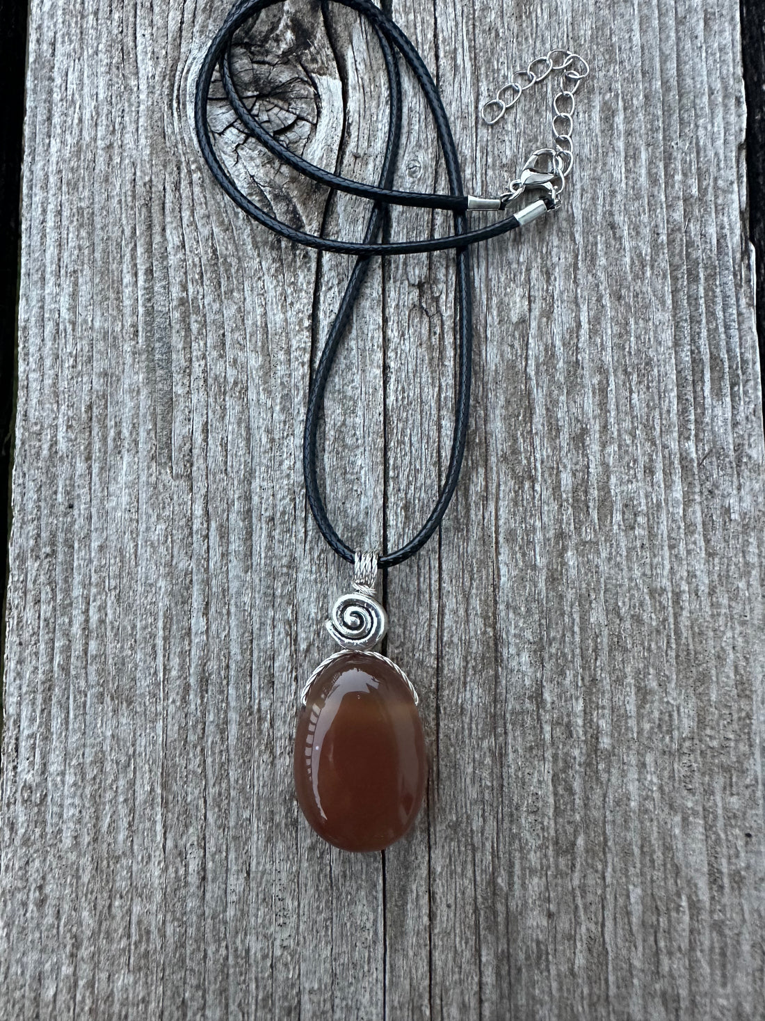 Carnelian for Courage, Success and Creativity. Swirl to Signify Consciousness.