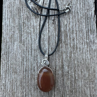 Carnelian for Courage, Success and Creativity. Swirl to Signify Consciousness.