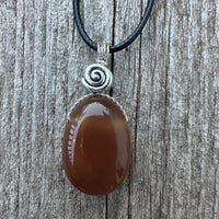 Carnelian for Courage, Success and Creativity. Swirl to Signify Consciousness.