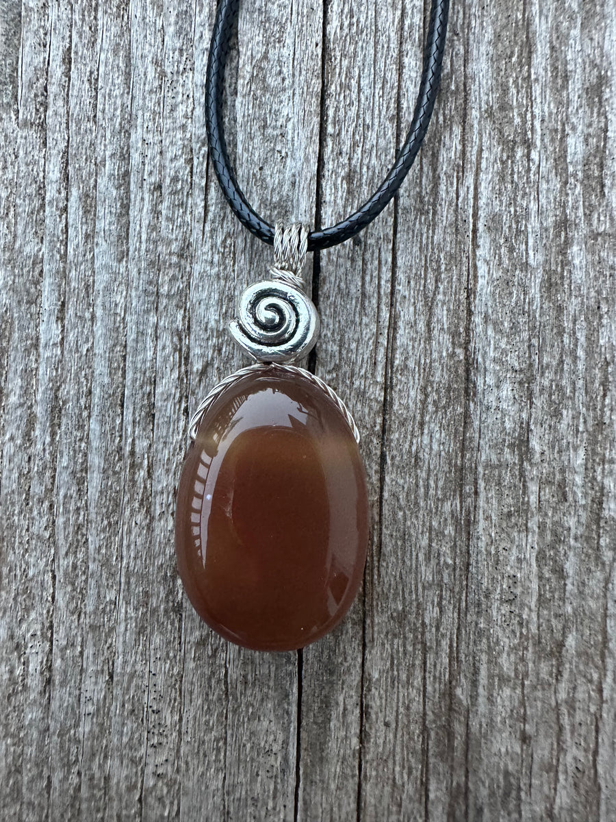 Carnelian for Courage, Success and Creativity. Swirl to Signify Consciousness.