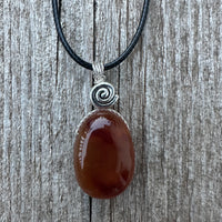 Carnelian for Courage, Success and Creativity. Swirl to Signify Consciousness.