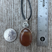 Carnelian for Courage, Success and Creativity. Swirl to Signify Consciousness.