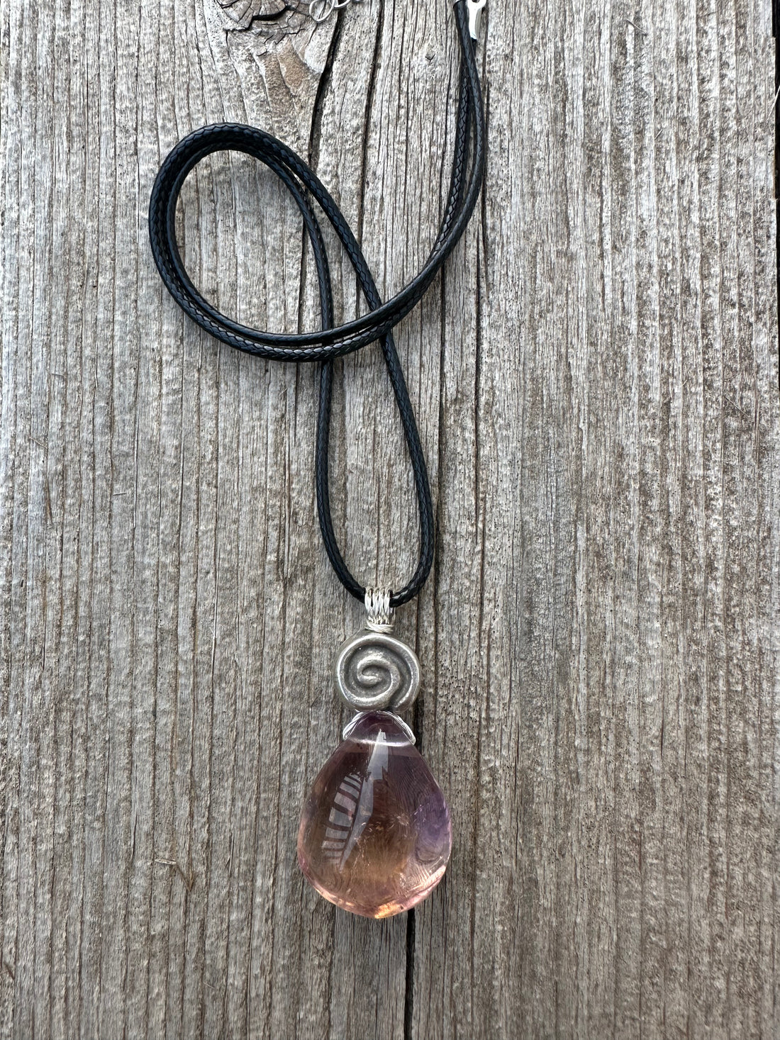 Ametrine for Connecting Physical and Metaphysical Realms, Clarity, and Harmony. Swirl to Signify Consciousness.