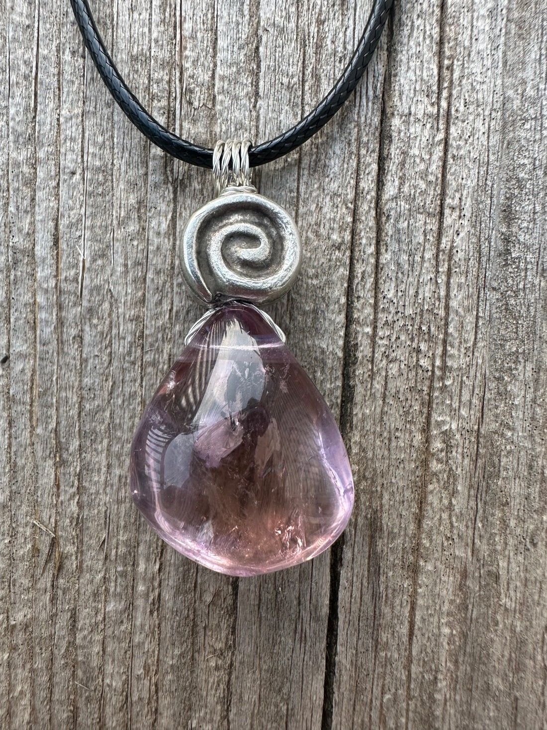 Ametrine for Connecting Physical and Metaphysical Realms, Clarity, and Harmony. Swirl to Signify Consciousness.