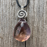 Ametrine for Connecting Physical and Metaphysical Realms, Clarity, and Harmony. Swirl to Signify Consciousness.