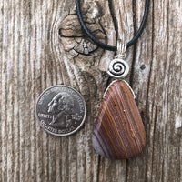 Rhyolite for Igniting Potential, Strength and Creativity. Swirl to Signify Consciousness.