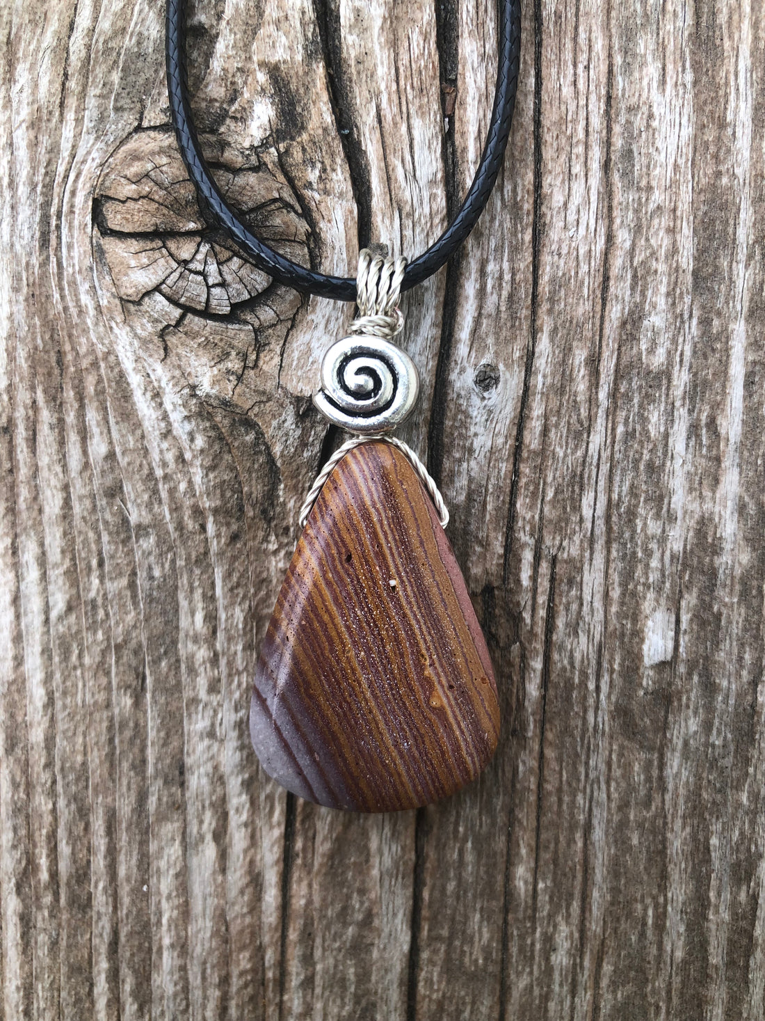 Rhyolite for Igniting Potential, Strength and Creativity. Swirl to Signify Consciousness.