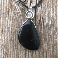 Natural Onyx for Strength, Vigor and Confidence. Swirl to Signify Consciousness.