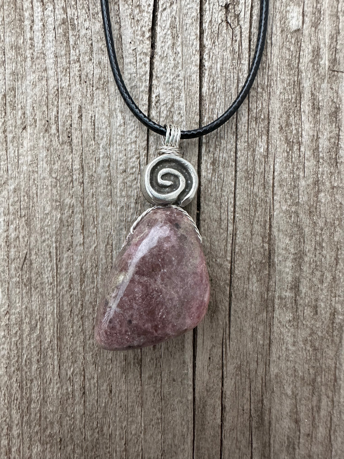 Rhodonite for Compassion, Balancing Emotions, and Self Confidence. Swirl to Signify Consciousness.