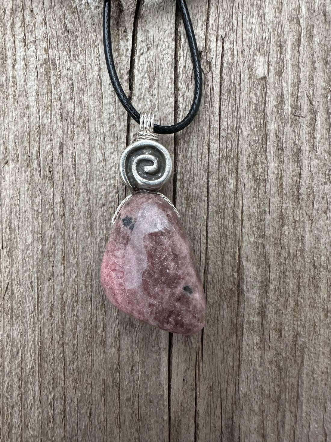 Rhodonite for Compassion, Balancing Emotions, and Self Confidence. Swirl to Signify Consciousness.