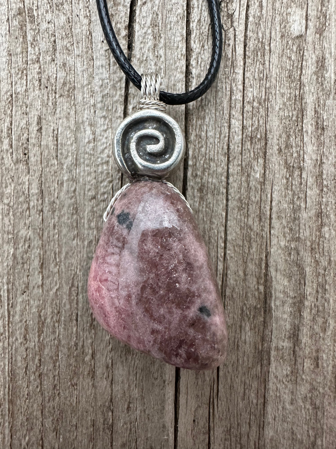 Rhodonite for Compassion, Balancing Emotions, and Self Confidence. Swirl to Signify Consciousness.