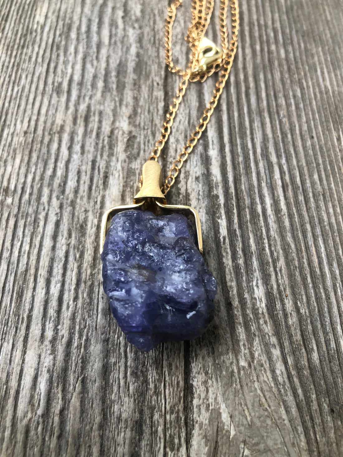 Raw Tanzanite for Communication on All Levels, Purpose and Creativity. 14 Karat Gold Plated Holder and Chain.