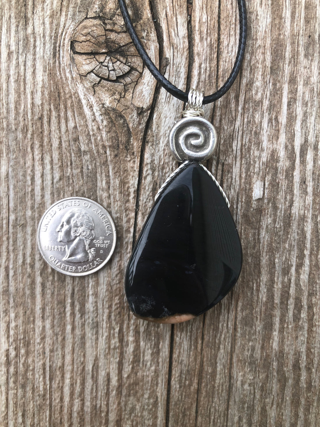 Natural Onyx for Strength, Vigor and Confidence. Swirl to Signify Consciousness.