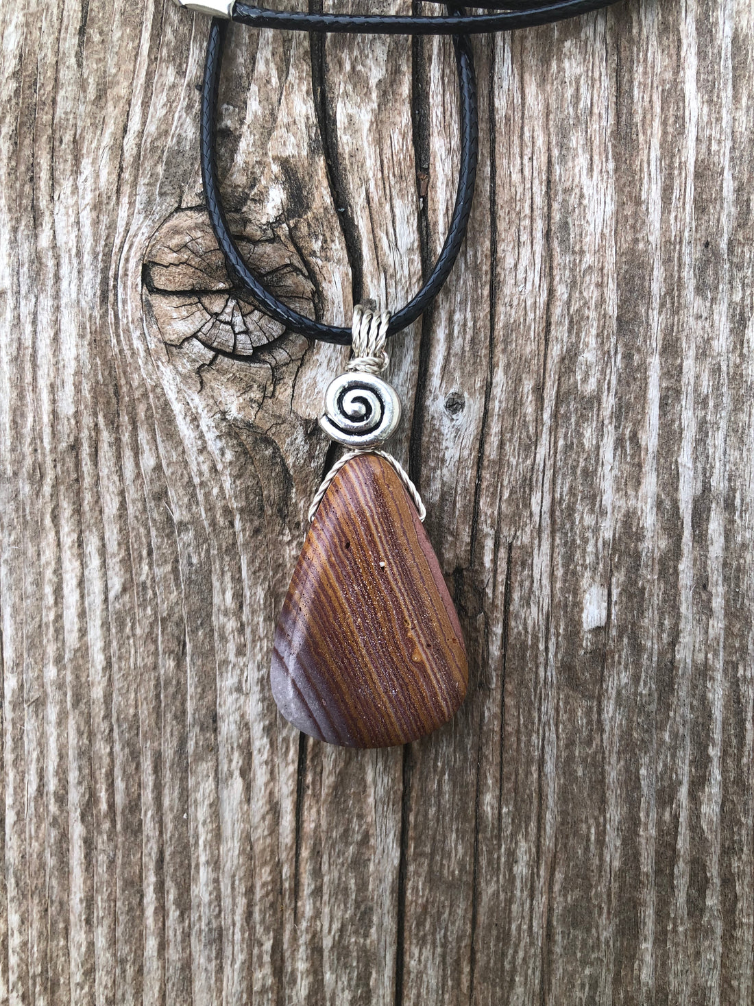 Rhyolite for Igniting Potential, Strength and Creativity. Swirl to Signify Consciousness.